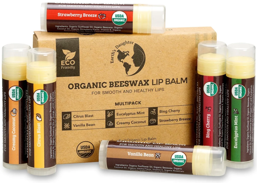 A cardboard box for Earth's Daughter Organic Beeswax Lip Balm surrounded by six individual tubes in assorted flavors with USDA Organic seals.