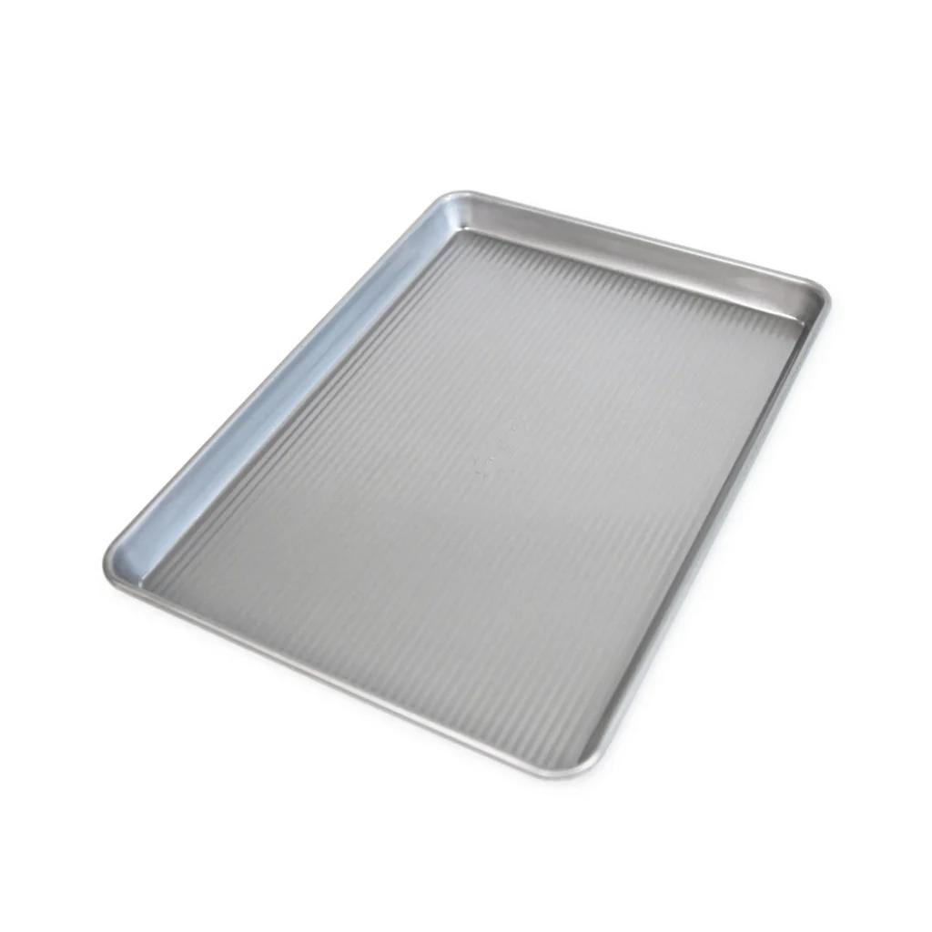 USA Pan aluminized steel half sheet baking pan showing corrugated ribbed surface texture.